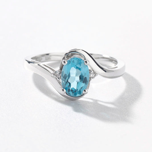 Oval Blue Topaz Ring With Diamond Accents in 10K White Gold