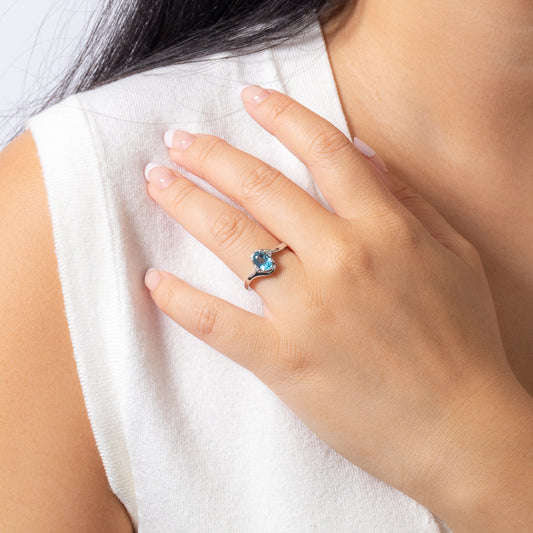 Oval Blue Topaz Ring With Diamond Accents in 10K White Gold